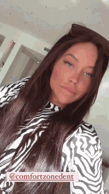 a woman is wearing a zebra print shirt and sunglasses and has the hashtag @comfortzonedent below her