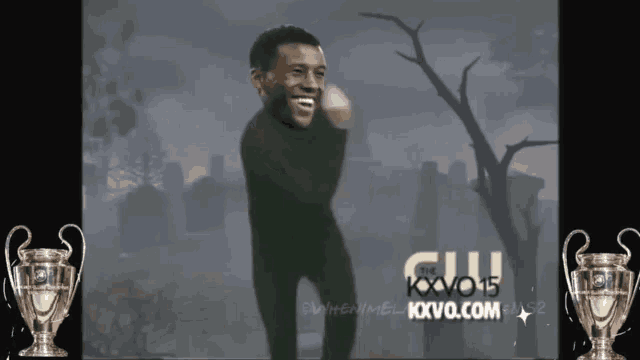 a man is dancing in front of a tv screen that says the kxvo15