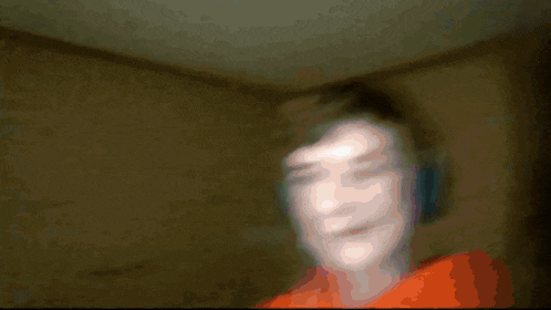 a boy wearing headphones and an orange hoodie