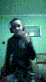 a blurry picture of a person wearing headphones giving the middle finger