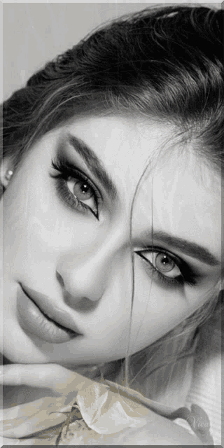 a woman 's face is shown in a black and white photo