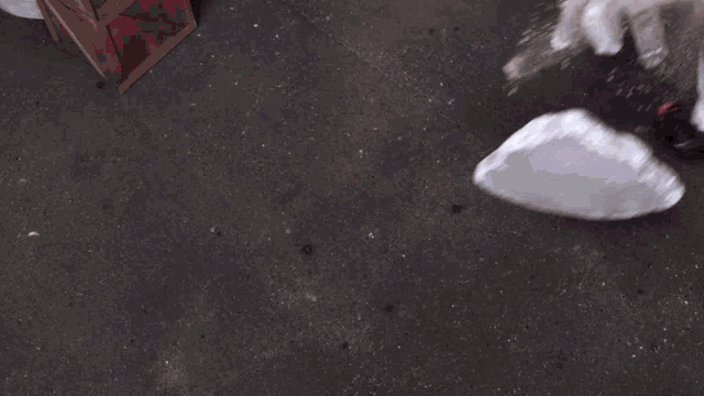a person in a santa claus costume is breaking ice cubes on the ground