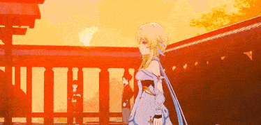 a girl in a white dress is standing in front of a building at sunset .