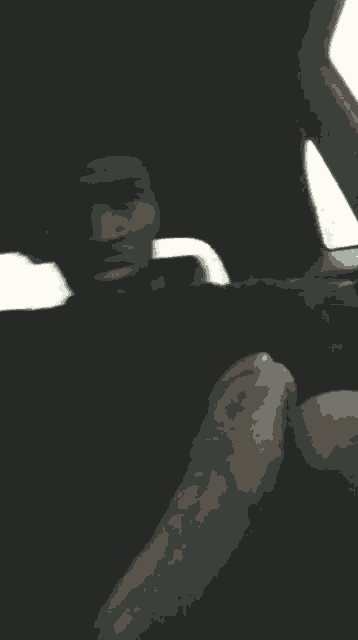 a man with a beard is sitting in a car