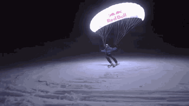 a person is flying a parachute that says red bull