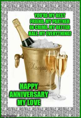 a bottle of champagne is in a bucket of ice with two glasses of champagne