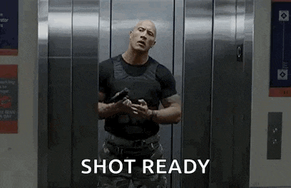 a man is standing in an elevator holding a gun and saying shot ready .