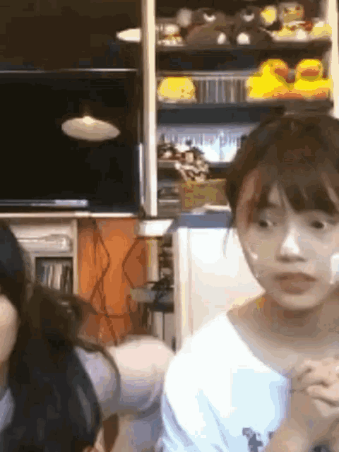 a woman with a bandage on her face is sitting in front of a tv