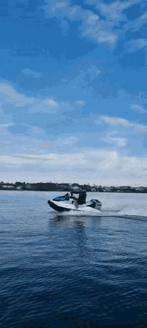 a person is riding a jet ski on a body of water