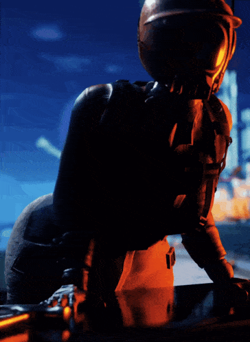 a man in a helmet is standing in the dark with a city in the background