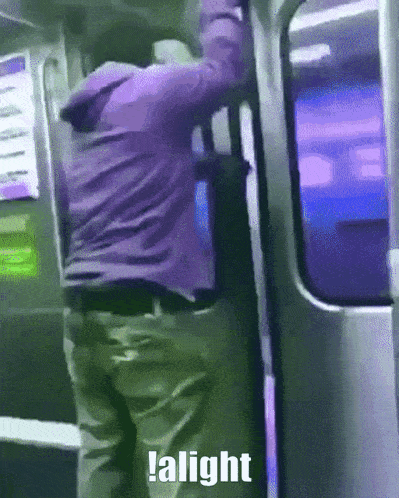 a man in a purple jacket is getting on a train and the word alight is on the bottom of the image