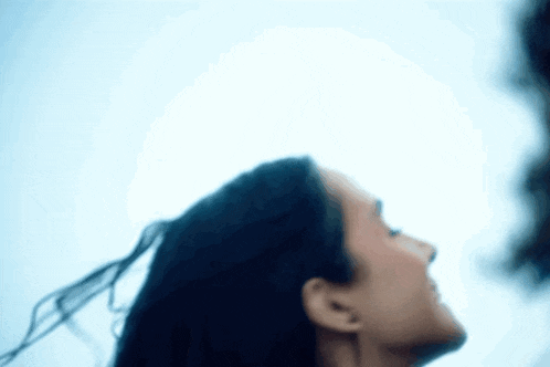 a woman with her hair blowing in the wind