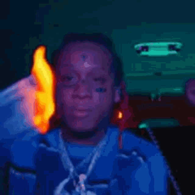 a person is holding a burning piece of paper