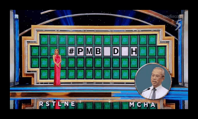 a woman in a red dress is standing in front of a wheel of fortune game board