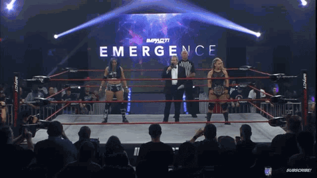 two women in a wrestling ring with the word emergence on the screen