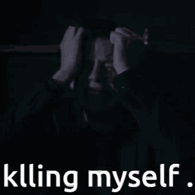 a man covering his face with his hands and the words killing myself