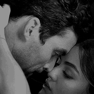 a man and a woman are hugging and kissing in a black and white photo .