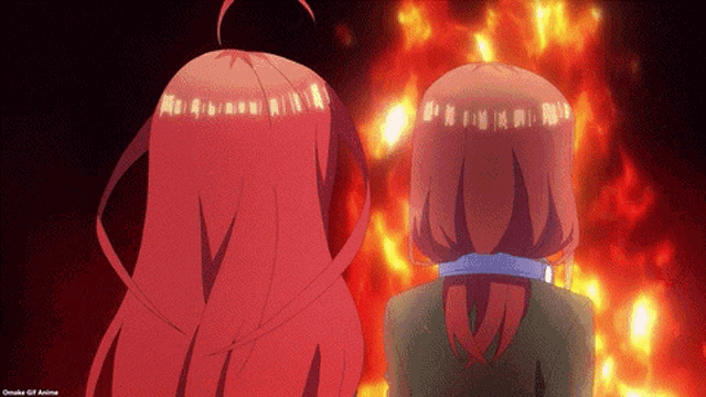 two anime characters are standing in front of a fire .
