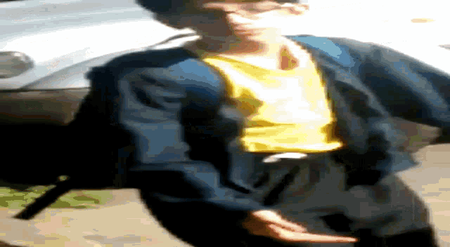 a man in a yellow shirt is laying on his back on the ground