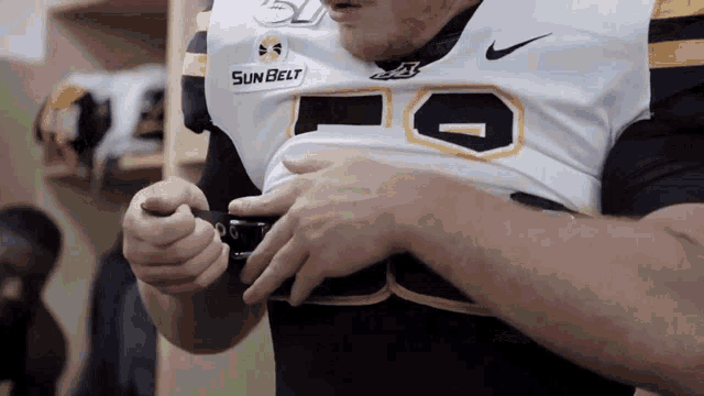 a man is wearing a sun belt jersey