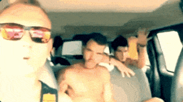 a man wearing sunglasses is taking a picture of himself and two other men in a car