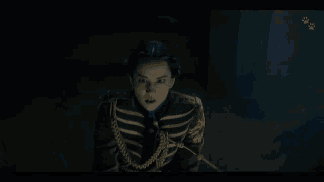a person in a dark room with a belt that has a buckle that says ' a ' on it
