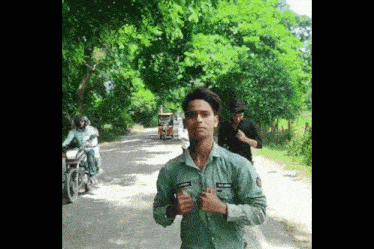 a young man wearing a green shirt with the name mr. jain on it