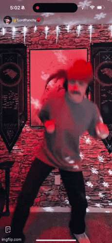 a man is dancing in front of a stone wall and a banner that says ' stark ' on it