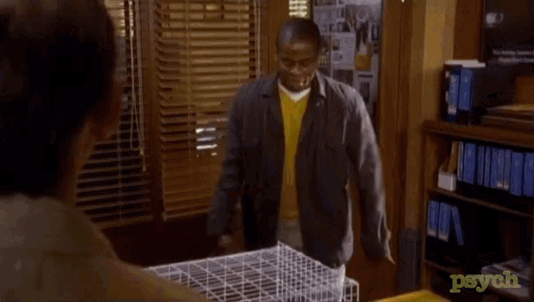 a man is kicking a cage with the word psych on the table