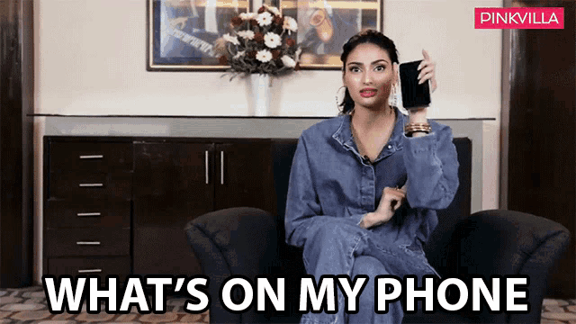 a woman sitting in a chair holding a cell phone with the words what 's on my phone written below her