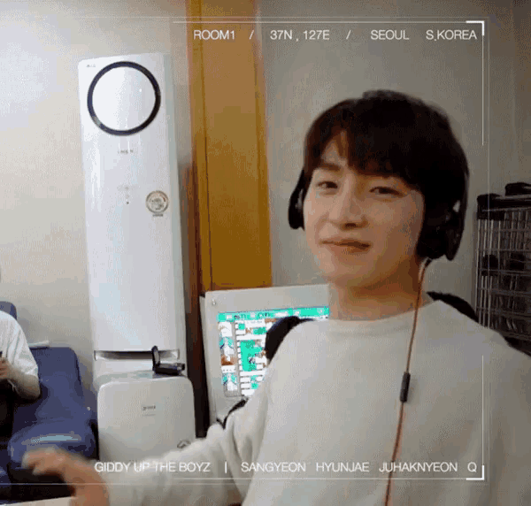 a young man wearing headphones is standing in a room with 37 degrees north and 127 degrees east ..