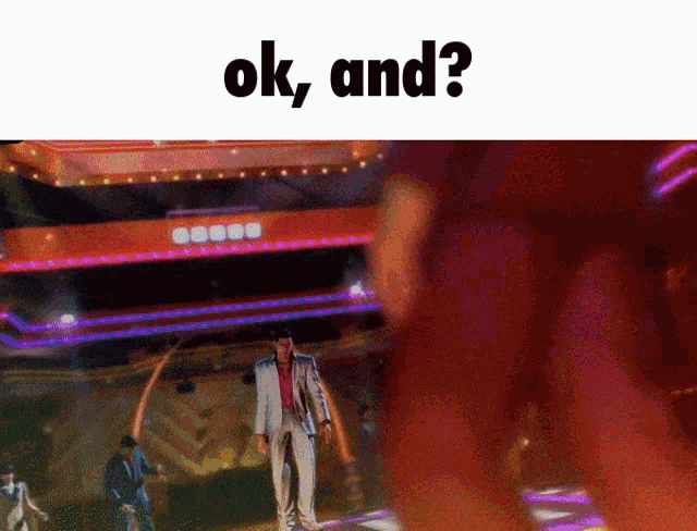 a man in a suit stands in front of a sign that says ok and on it