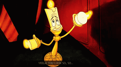 a cartoon character from beauty and the beast is holding a lit candle