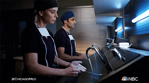 two doctors are washing their hands in a sink with the hashtag #chicagomed on the bottom