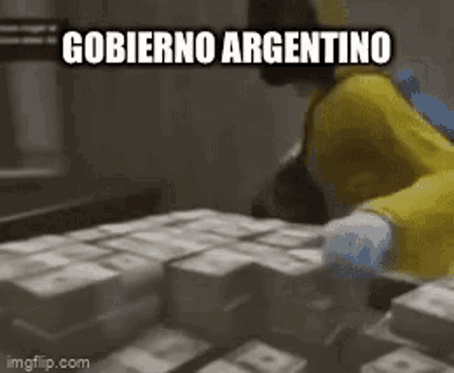 a person in a yellow jacket is standing in front of a stack of money .