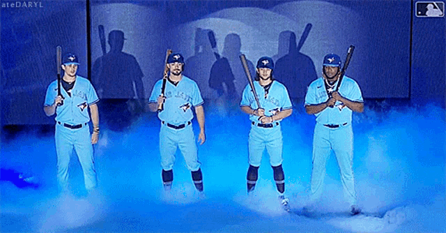 a group of blue jays baseball players are standing in a foggy room