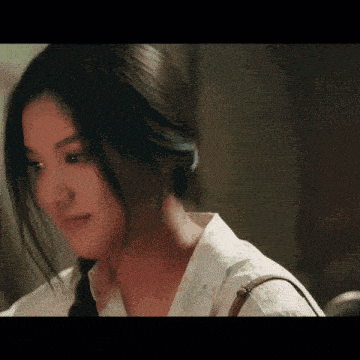 a close up of a woman 's face with a white shirt on