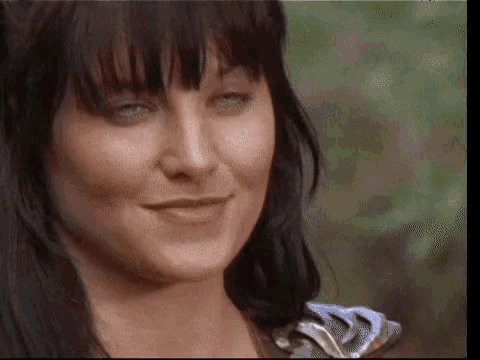 a close up of a woman 's face with a blurry background .