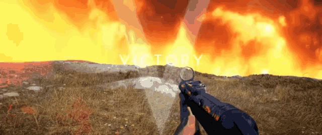 a person is holding a gun in front of a fire and the word victory is visible