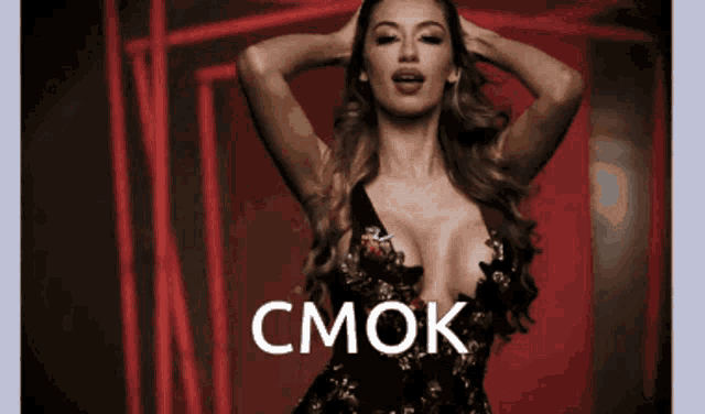 a woman in a very revealing dress with the word cmok on the bottom