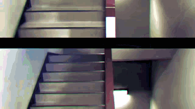 a staircase with a red railing is shown in a blurry photo