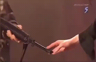 a close up of a person holding a microphone with the number 5 on the bottom