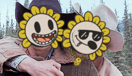 a man wearing a cowboy hat is hugging another man with two sunflowers on his faces