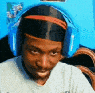 a man wearing headphones and a headband makes a funny face