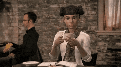 a woman with pigtails is holding a cup of coffee