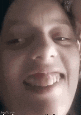 a close up of a person 's face with their eyes closed and a smile on their face .