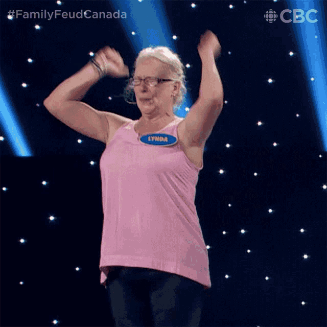 a woman in a pink tank top has a name tag that says lynda on it