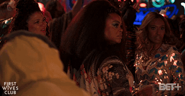 a group of women are dancing at a first wives club