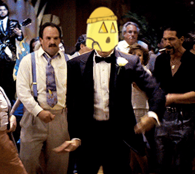 a man in a tuxedo has a mask on his face that says aa on it