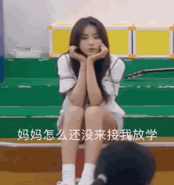a girl is sitting on a set of stairs with her hands on her chin